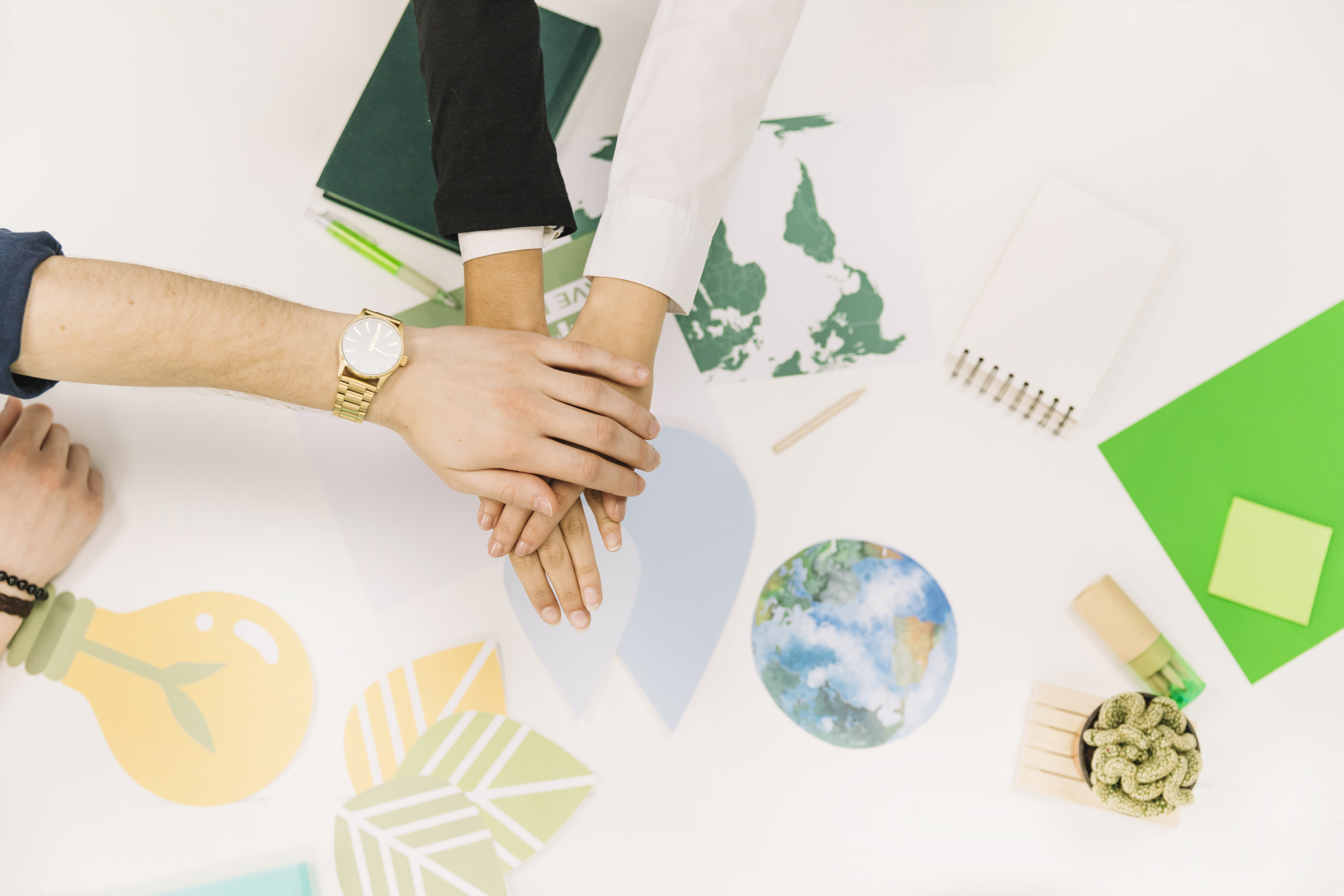 group-of-businesspeople-stacking-their-hands-over-desk (1)